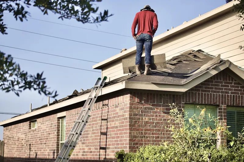 Professional roofer working on a residential roof in Doaneville
